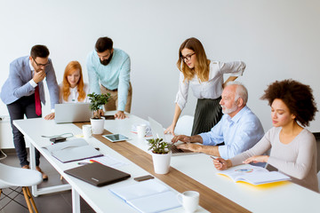 Joyful multiracial business team at work in modern office