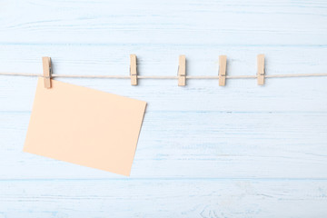 Blank paper hanging on rope with clothespins