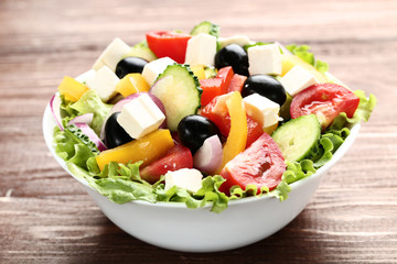 Vegetable salad in bowl on brown wooden table