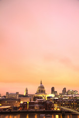 Fototapeta premium Saint Pauls Cathedral and Millennium Bridge from tate modern with pink sunset hdr