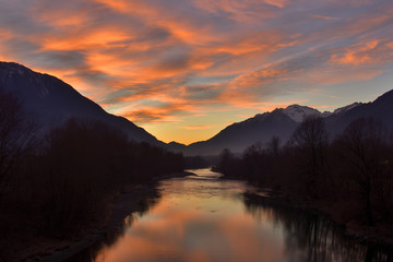 Painted clouds over Adda river.