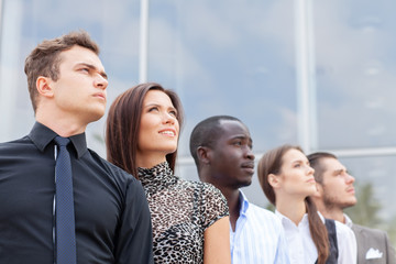 business team standing in a row at office and looking upwards - Successful business team.