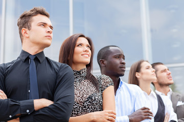business team standing in a row at office and looking upwards - Successful business team.