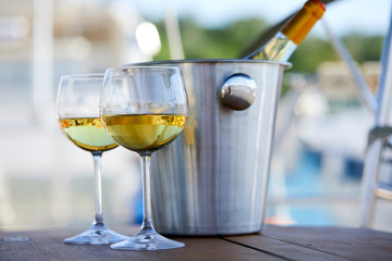 Pair of wineglasses against the yacht