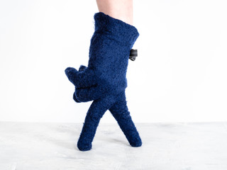 hand in blue glove with bow tie shows gentleman