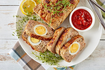 sliced hot Meatloaf served with tomato sauce