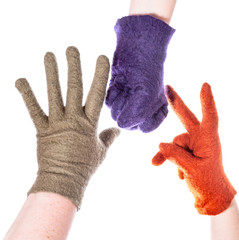 hands in woolen gloves show rock-paper-scissors