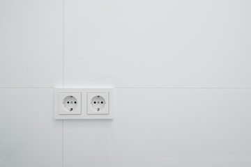 socket,  electric plug outlets on white tiles -