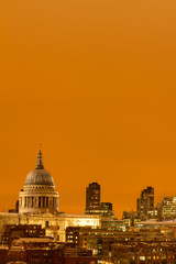 Fototapeta na wymiar Saint Pauls Cathedral as seen from tate modern while an orange sunset acts a backdrop