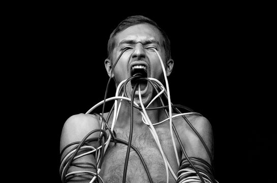 person wrapped wires, wires come out of the mouth and eyes