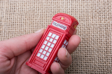  Hand holding a phone booth on a canvas background
