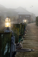 Fog in the morning at the boardwalk boat harbor.