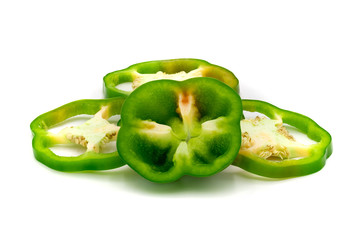 Green bell pepper slices isolated on white background.