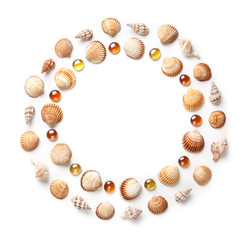 Pattern of shells and orange glass beads in the shape of a circle. Frame or design element. isolated on white background
