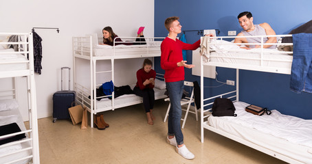 Travelers communicating in hostel bedroom