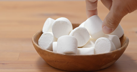 Fototapeta na wymiar White marshmallow on wooden plate