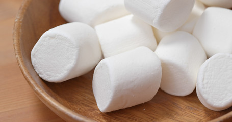 Fototapeta na wymiar White cotton candy on wooden plate