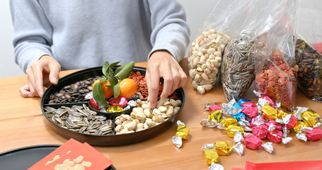 Woman fill with snack of the box for lunar new year