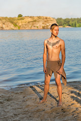 guy in loincloth on the background of river beach