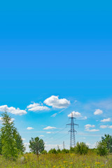 Template with a high-voltage power line in a field against a blue sky with an empty place for text