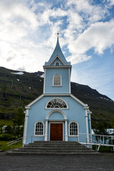 Fototapeta na wymiar A church in Seydisfjordur cityscape in East Iceland in summer on a cloudy day