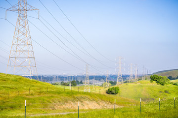 High voltage electricity towers in the morning on a blue sky background, California