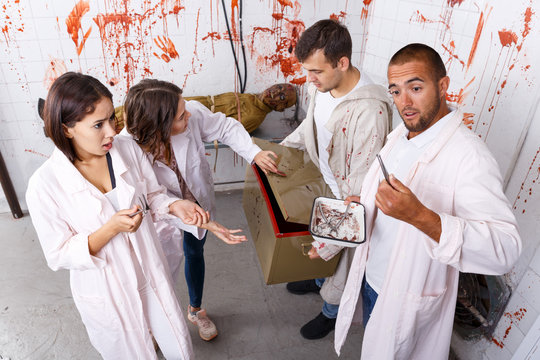 Young adults in escape room with traces of blood