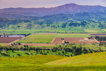 Fototapeta na wymiar Aerial view of agricultural fields, mountain background, south San Francisco bay, San Jose, California