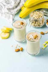 Banana ginger cinnamon almond smoothie with coconut flakes. Selective focus, space for text.