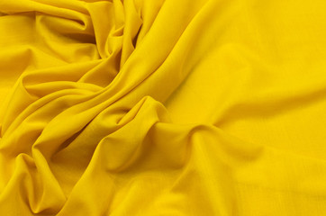 Close-up texture of natural orange or yellow fabric or cloth in same color. Fabric texture of...