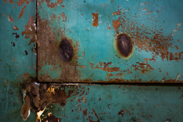 Door of an old, steel safe with traces of hacking attempts close-up