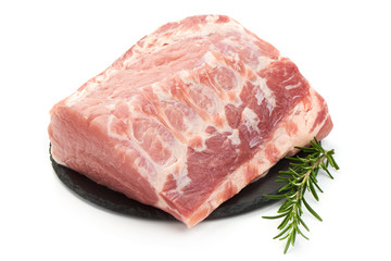 Raw pork neck meat with rosemary, isolated on white background. Close-up