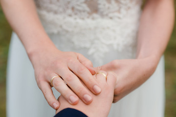 hands of bride and groom and wedding rings
