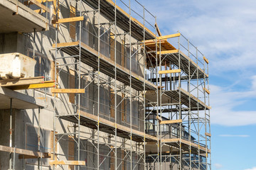 Photo of multistory high rise building with scaffolding