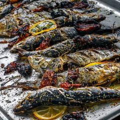Delicious baked sardines on a tray. Healthy meal made of fresh fish.