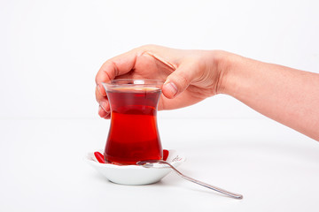 One cup of tea woman's in hand on white background. 
