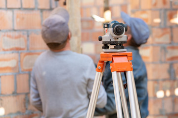 Surveyor device against blurred background inside incomplete house