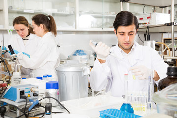 Man pipetting reagent in test tube
