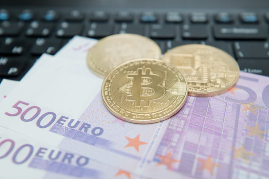 Golden Bitcoin on Euro Banknote. Symbolic image of virtual currency.