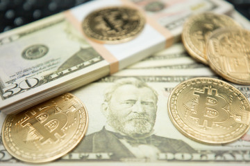 Golden bitcoin coin on us dollars close up. Symbolic image of virtual currency.