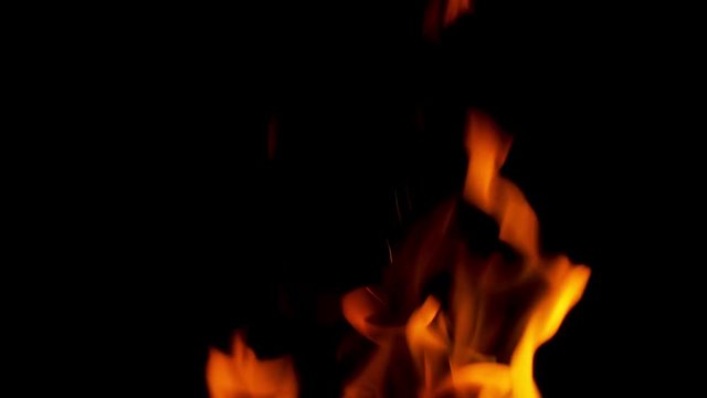 Open fire close-up burning logs. Atmosphere of heat, the background