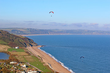 Paragliders flying above Start Bay at Beesands