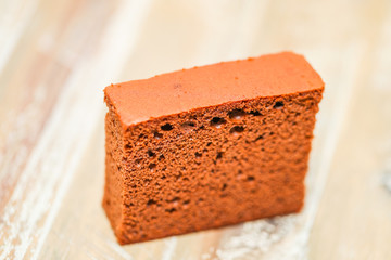Delicious chocolate cake on plate on table on light background - Image