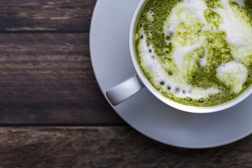 Matcha green tea latte on wooden table