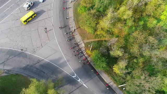 Shooting a running half-marathon athletes between the forest and the railway from a bird's eye view