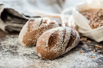 fresh bread with flour on the wooden background