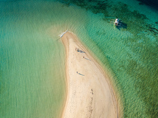 Aerial view of tropical  beach on island Ditaytayan. Beautiful tropical island with white sandy beach, palm trees and green hills. Travel tropical concept. Palawan, Philippines