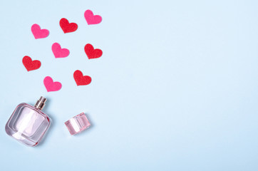 Flat lay arrangement of hearts and perfume bottle for mock up design, table top view image of...
