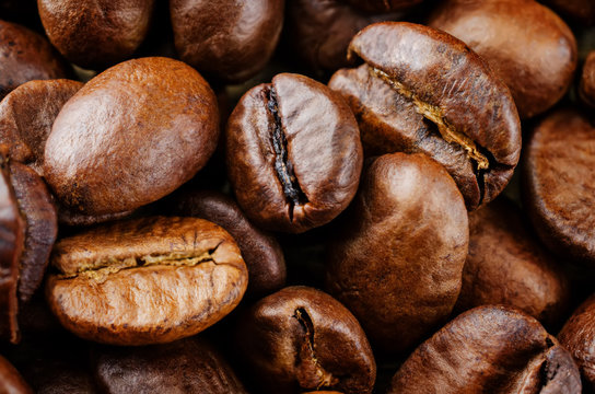 Coffee beans on a dark wood background © nata_vkusidey