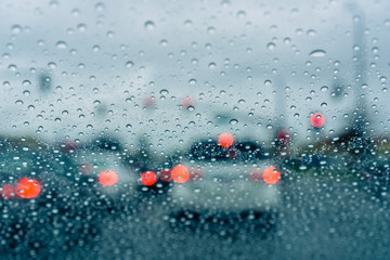 Heavy traffic during a rainy day; raindrops on the window